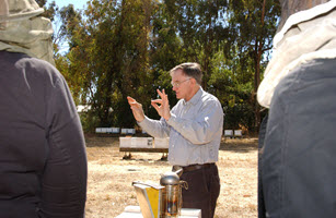Eric Mussen discussing honey bee biology to a group at the Harry H. Laidlaw Jr. Honey Bee Research Facility, UC Davis.